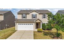 Two-story home featuring neutral siding, a two-car garage, and professionally landscaped front yard at 2522 Dalmahoy Ln, Fuquay Varina, NC 27526