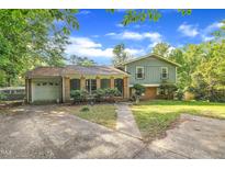 Charming two-story home featuring a brick facade, front porch, and attached garage at 2608 Foxgate Dr, Raleigh, NC 27610