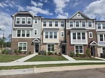 New townhome exteriors feature diverse textures, individual entryways, and beautifully landscaped front yards at 3026 Freewinds Way # 50, Cary, NC 27519