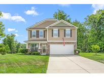 Charming two-story home with stone accents, manicured lawn, and attached two-car garage at 4221 Northrop Dr, Haw River, NC 27258