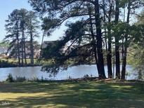 Scenic lake view lot with mature trees, perfect for building a dream home with waterfront access at 46 Black Walnut Dr # 197, Garner, NC 27529
