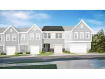 Charming townhome showcases a contemporary facade with stone accents, a garage, and lush landscaping at 5017 Shipper Ln, Durham, NC 27703