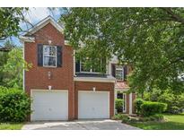 Charming two-story brick home features a two-car garage and manicured landscaping at 510 N Waters Edge Dr, Durham, NC 27703