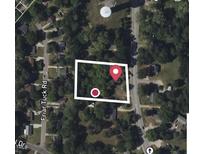 Aerial view of a property with a house nestled among trees near Friar Tuck Road at 630 Sunnybrook Rd, Raleigh, NC 27610