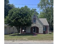 Charming stone and brick home with mature tree, arched entry, and well-maintained lawn at 808 Belvedere St, Rocky Mount, NC 27803