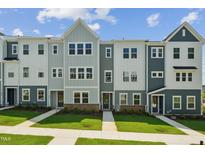 Charming row of townhomes with well-manicured lawn and inviting entrances at 808 Hillfarm Dr, Wake Forest, NC 27587