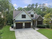 Beautiful two-story home with a stone facade and a spacious two-car garage at 1005 Collins Dr, Raleigh, NC 27609
