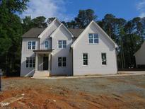 New construction home with painted brick, gable roof, and professionally landscaped yard at 1444 Old Apex Rd, Cary, NC 27513