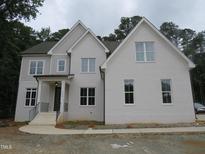 Charming two-story home boasts brick facade, elegant windows, and covered front porch at 1444 Old Apex Rd, Cary, NC 27513