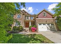 Charming two-story home with a well-maintained lawn, stone accents, and a welcoming entrance at 208 Bellagio Dr, Apex, NC 27539