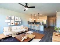 Open-concept living room and kitchen with modern finishes and comfortable seating arrangement at 2205 Gathering Square Ct, Fuquay Varina, NC 27526