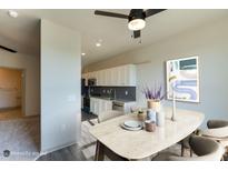 Bright dining area with modern decor and open access to the kitchen at 2316 Gathering Square Ct, Fuquay Varina, NC 27526