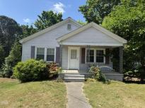 Charming one-story home featuring a quaint front porch and a well-maintained lawn at 304 Culvert St, Apex, NC 27502