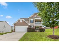 Charming two-story home with a two car garage, balcony, and manicured lawn at 3832 Stovall Dr, Haw River, NC 27258