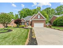 Charming brick home with a manicured lawn, two-car garage, and elegant landscaping at 480 Whitt Ave, Burlington, NC 27215