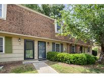 Charming townhome featuring a distinctive brown roof, tidy landscaping, and a welcoming entrance at 4822 Blue Bird Ct # B, Raleigh, NC 27606