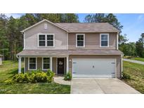 Charming two-story home with a well-manicured lawn and an attached two-car garage at 6007 Austin Falls Ct, Liberty, NC 27298