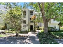 Charming condo with traditional architecture, featuring private balconies and lush landscaping at 6120 Sunpointe Dr # 102, Raleigh, NC 27606