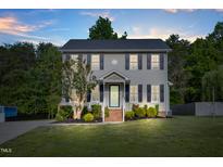 Charming two-story home with gray siding, black shutters, and manicured front yard at 827 Lockesley Ln, Burlington, NC 27217