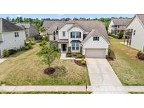 Two-story home featuring a two-car garage, neutral siding, and a manicured lawn at 912 Beech Glen Dr, Mebane, NC 27302