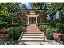Beautiful brick home with a manicured lawn and a welcoming front entrance with mature trees at 117 Hillcrest Rd, Raleigh, NC 27605