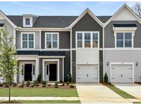 Charming new construction townhomes featuring gray siding, white trim, and inviting front yards at 158 Ripple Way # 321, Clayton, NC 27520