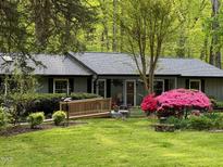 Charming single-story home with a lovely front yard, lush lawn and beautifully landscaped flowerbeds at 220 Cardinal Dr, Youngsville, NC 27596