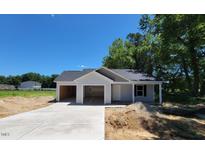 Newly constructed single-story home with an attached two-car garage and a concrete driveway at 2555 Whitetail Rd, Nashville, NC 27856