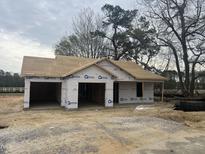 Image displays new construction of a single-story home with an attached two-car garage, awaiting finishing touches at 2555 Whitetail Rd, Nashville, NC 27856