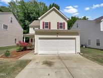 Charming two-story home with a two car garage, red shutters, and well-maintained landscaping at 3223 Polite Ln, Raleigh, NC 27610