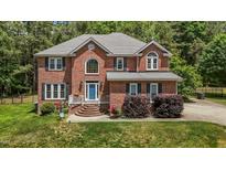 Charming brick home featuring a well-manicured lawn and inviting front entrance at 4225 Old Lewis Farm Rd, Raleigh, NC 27604