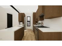 A modern kitchen featuring stainless steel appliances, wood cabinetry, a window and light wood floor at 512 Gordon Street # 304, Durham, NC 27701