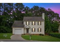 Charming two-story home featuring well-manicured lawn and attached garage, perfect curb appeal at 8004 Mill Bluff Ct, Raleigh, NC 27616
