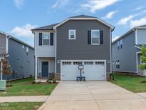 Two-story home with a two-car garage and a well-manicured lawn at 805 Ottawa Dr, Garner, NC 27529