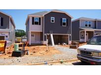 New two-story home under construction with dark siding and a two-car garage ready for customization at 805 Ottawa Dr, Garner, NC 27529