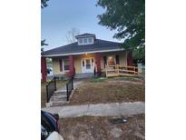 Charming single-story home featuring a peaked roof, decorative dormer, and inviting front porch with ramp access at 1007 Grace Ave, Burlington, NC 27217