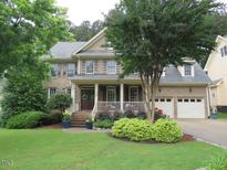 Charming brick home with a well-manicured lawn and inviting front porch at 1021 Golden Star Way, Wake Forest, NC 27587