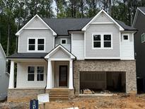 New construction with brick foundation, gray siding, and an attached 2-car garage at 118 Sanderway Dr, Chapel Hill, NC 27516