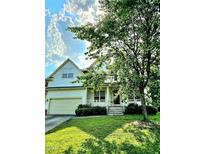 Charming two-story home features a front porch, two-car garage, and a well-maintained lawn with mature landscaping at 120 Hatchet Creek Ct Ct, Morrisville, NC 27560