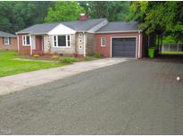 Charming single-story brick home with a well-maintained lawn and a paved driveway at 1610 W B St, Butner, NC 27509