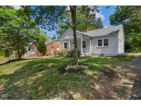 Charming single-story home with a welcoming front porch and mature trees in a residential neighborhood at 2206 Guess Rd, Durham, NC 27705