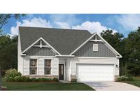 Inviting craftsman-style home featuring a two-car garage, stone accents, and beautifully manicured lawn at 227 Macon Lake Drive # 26, Apex, NC 27523