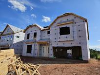 New two-story home under construction with visible wood framing and protective house wrap at 3006 Dog Rose Dr # 308, Durham, NC 27703