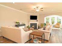 Inviting living room featuring a cozy fireplace and plenty of natural light from a large window at 3006 Dog Rose Dr # 308, Durham, NC 27703