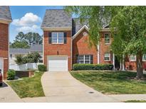 Charming two-story red brick home featuring a one-car garage and well-maintained landscaping at 368 Bayleigh Ct, Garner, NC 27529
