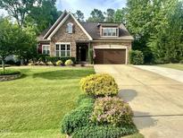 Charming stone-accented home with a well-manicured lawn and inviting curb appeal at 4405 Brighton Ridge Dr, Apex, NC 27539