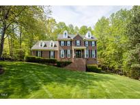Beautiful brick home with dormer windows and a well-manicured lawn at 5025 Martin Farm Rd, Raleigh, NC 27613