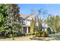 Charming two-story home with stone accents, covered porch, and professionally landscaped yard at 7516 Orchard Crest Ct, Apex, NC 27539