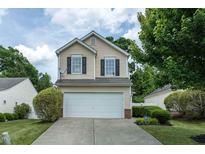 Charming two-story home with a well-manicured front lawn and attached two-car garage at 8908 Shallcross Way, Raleigh, NC 27617