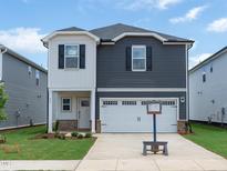 Charming two-story home featuring a two-car garage and a beautifully maintained lawn at 813 Ottawa Dr, Garner, NC 27529